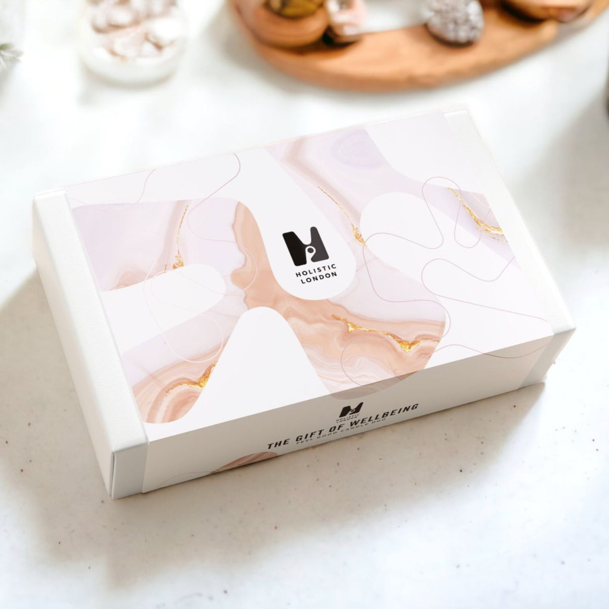 Holistic London Co Feel Good Candle Duo gift box with elegant pink and gold marble pattern on a white surface